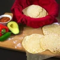 Homemade flour tortillas with a side of salsa and vegetables