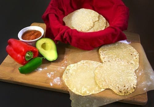 Homemade flour tortillas with a side of salsa and vegetables