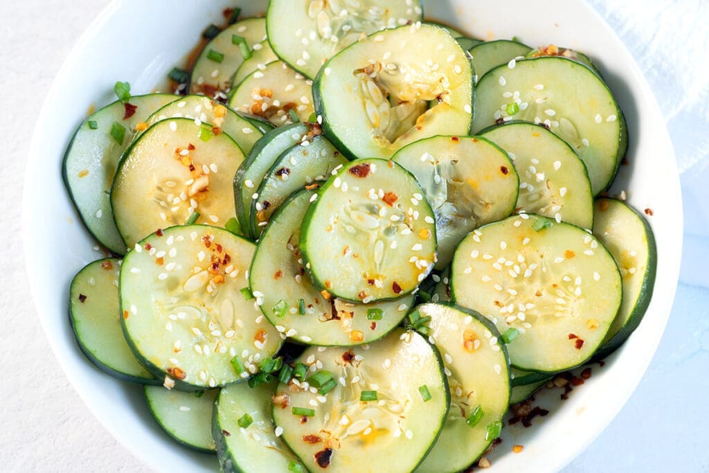 White bowl filled with spicy cucumber salad.