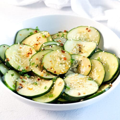 White bowl filled with spicy cucumbers.