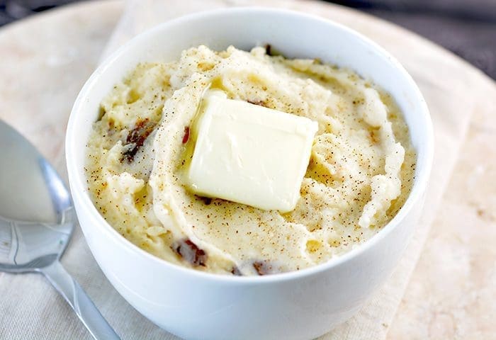 Crock Pot Mashed Potatoes with a pat of butter on top.