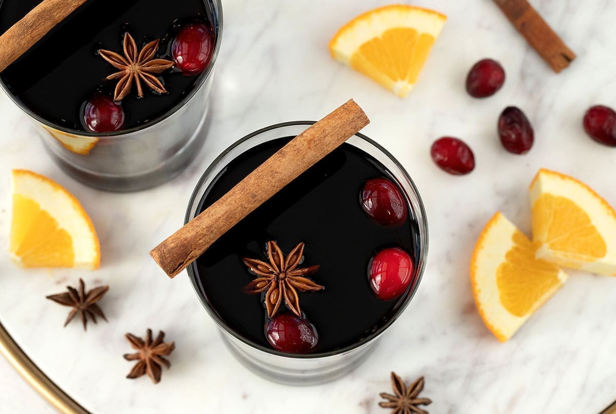 Two glasses of mulled wine with garnishes.
