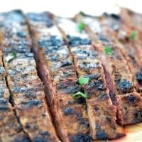 Up close shot of grilled flank steak sliced to make carne asada recipes.