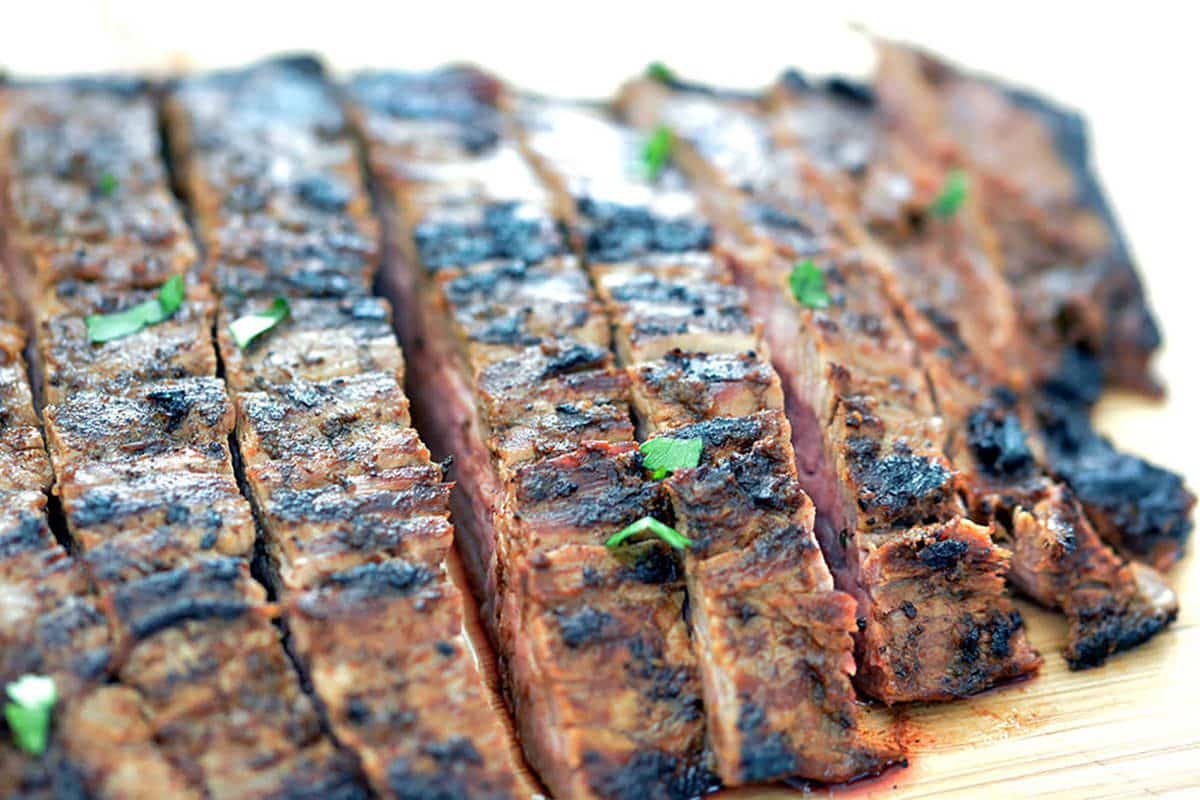Up close shot of grilled flank steak sliced to make carne asada recipes.