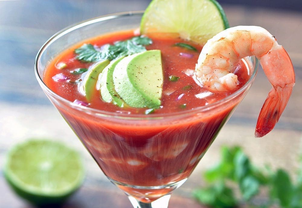 Mexican Shrimp Cocktail topped with a single shrimp and avocado.