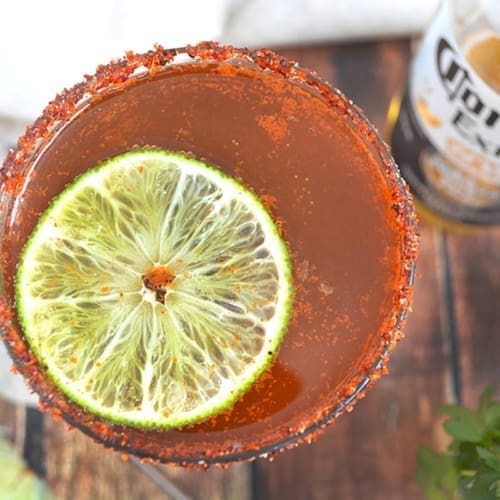 Top down picture of a michelada with a slice of lime.