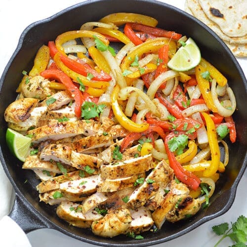 Chicken fajitas in a cast iron skillet.