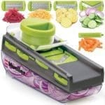 Picture of a mandoline slicer with various cut vegetables.