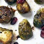 Balsamic Glazed Roasted Brussels Sprouts with dried cranberries on baking sheet.