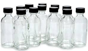 Picture of small 2 oz glass bottles with black lids.