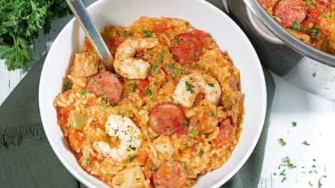 Instant Pot Jambalaya in a white bowl with a silver spoon.