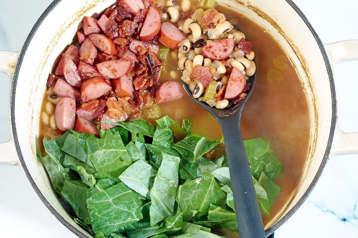 Cooked sausage, bacon, beans and greens for black eyed peas recipes.