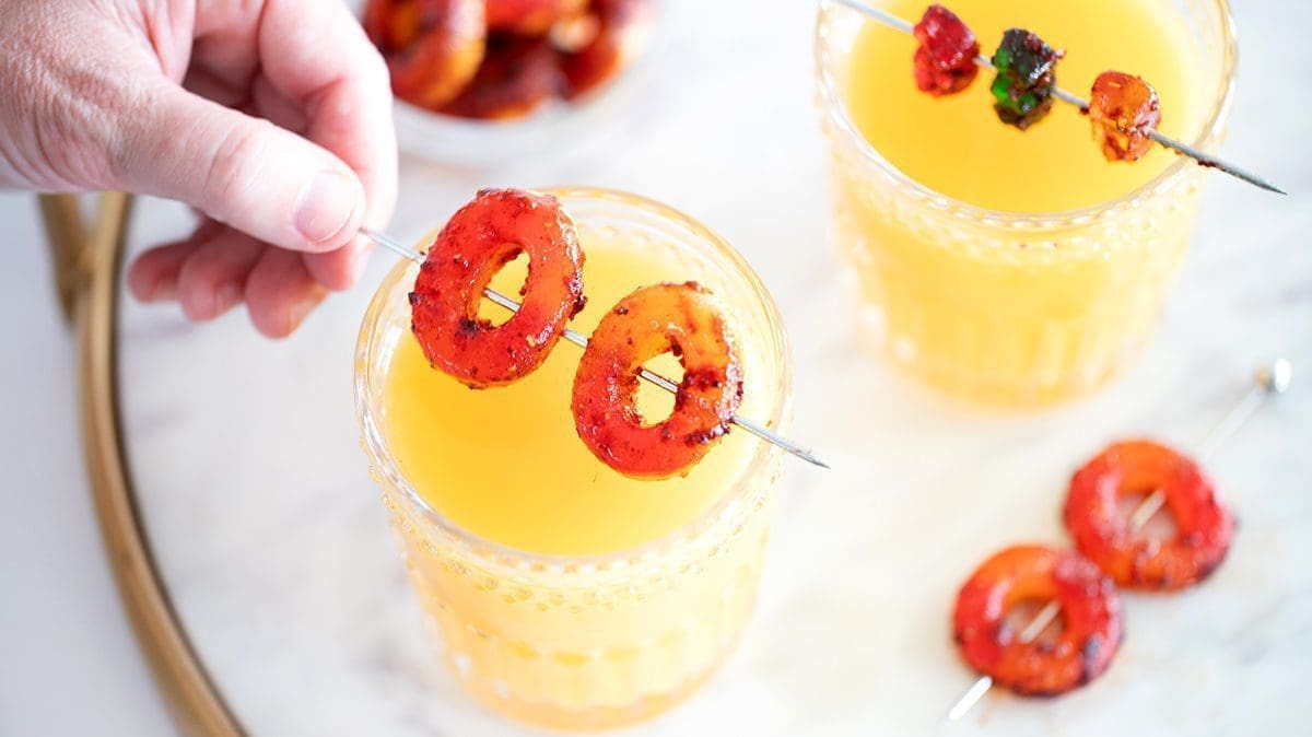 Peach rings and gummy bear garnishes on beermosa drinks.