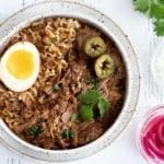 Bowl of Birria Ramen with a ramen egg on top.