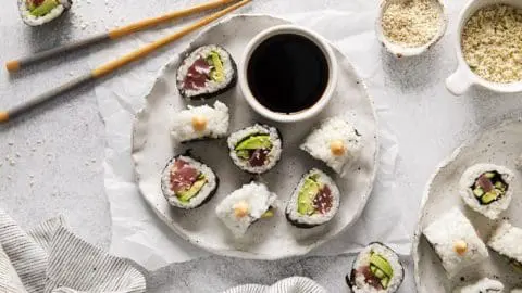 Crunchy Spicy Tuna Rolls on a white plate next to soy sauce.