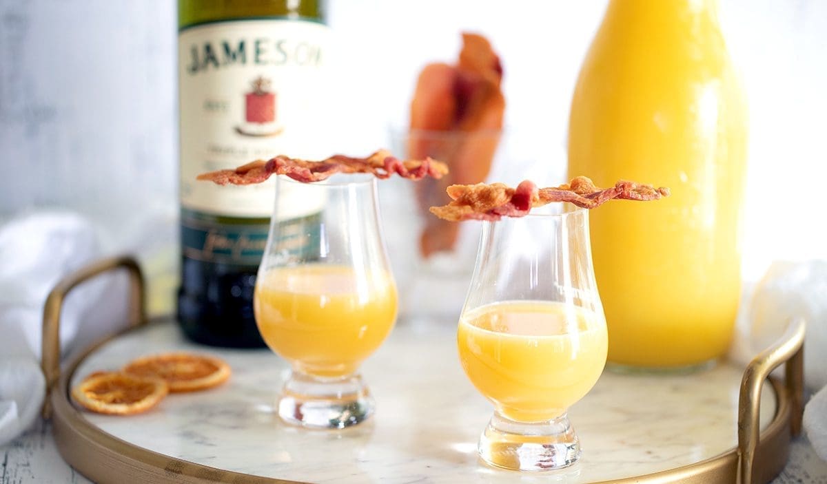Ingredients to make an Irish Breakfast Shot: orange juice, whiskey, schnapps and bacon.