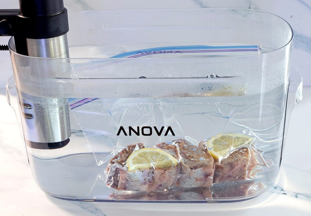 Uncooked lamb in a sous vide water bath.