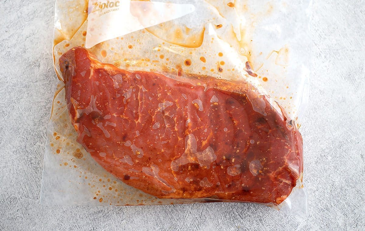 Beef roast marinating in a Ziploc bag.