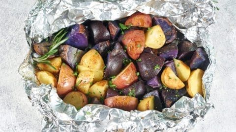 Smoked potatoes in a bowl of foil.