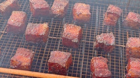 Pork Belly Burnt Ends on a gold grill basket.