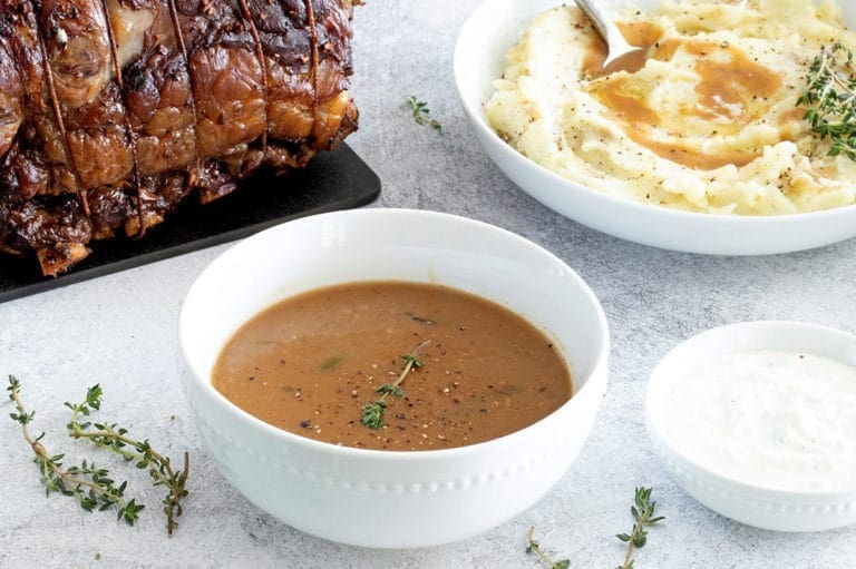 White bowl of prime rib gravy.