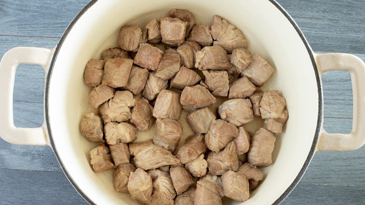 Cubed meat in a dutch oven.