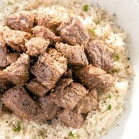 Cubes of pork on a bed of rice.