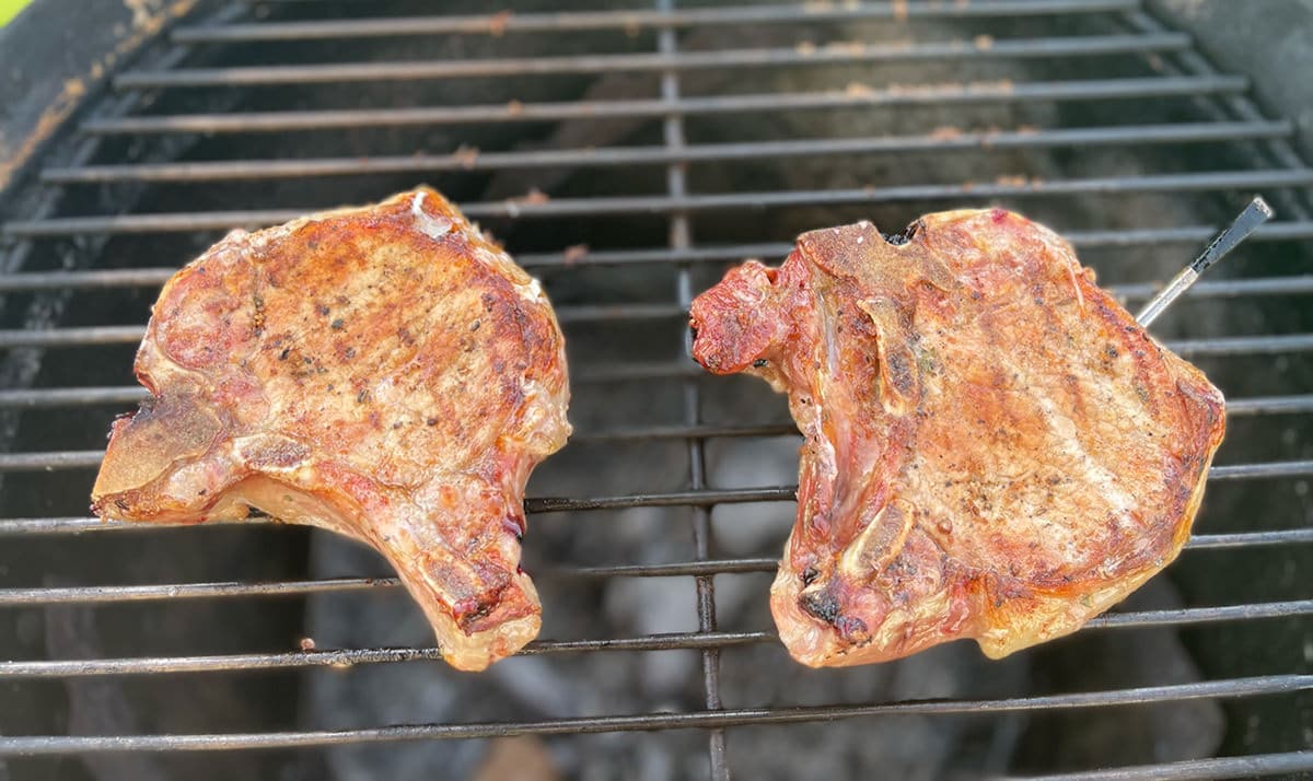Smoked pork chops on a grill.