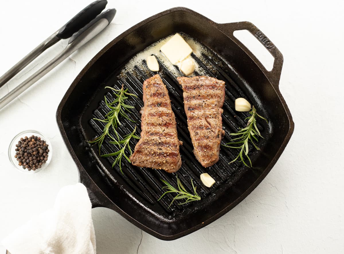 Denver Steak in a cast iron pan.