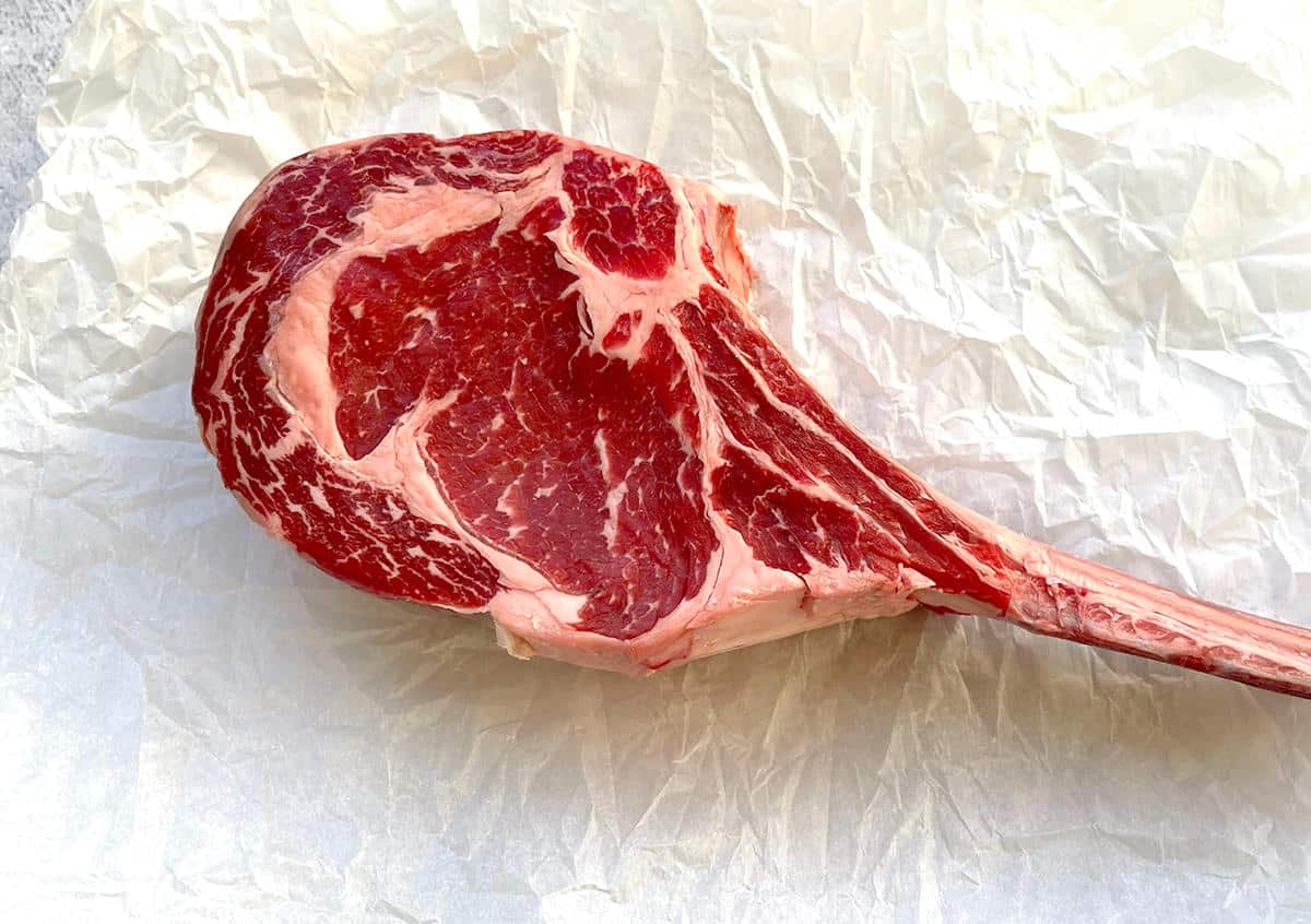Raw tomahawk steak.