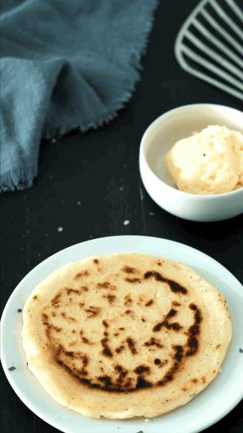 Gif file of an arepa con queso being torn into two pieces.
