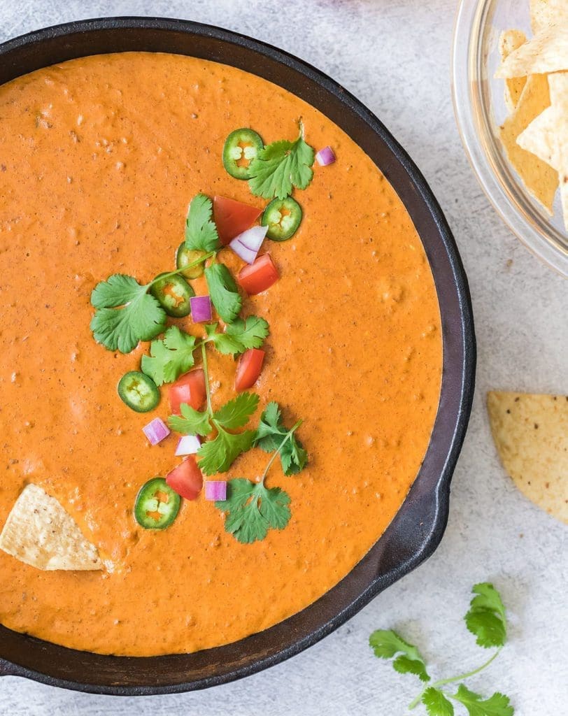 Overhead shot of queso topped with pico de gallo.