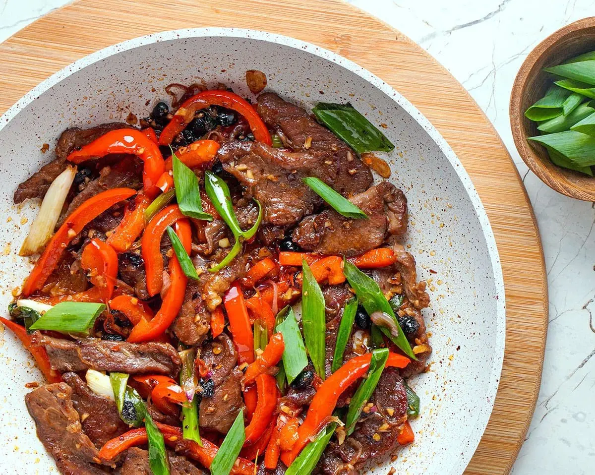 Hunan Beef in a large white bowl.