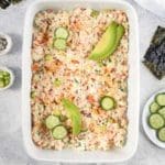 Baked sushi recipe in a white casserole dish.