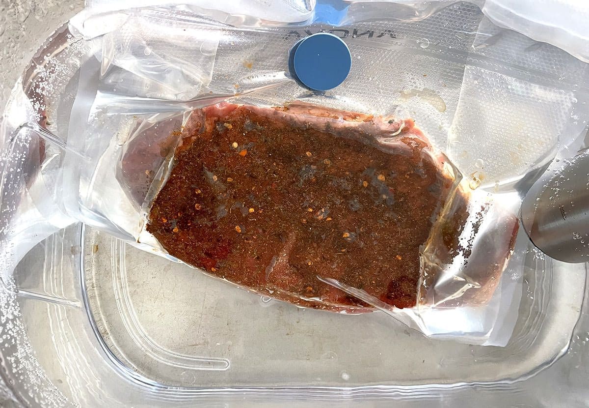 Beef in a sous vide water bath.