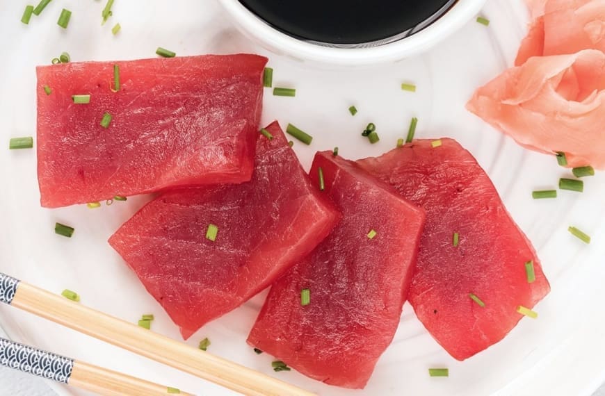 Tuna sashimi on a white plate.