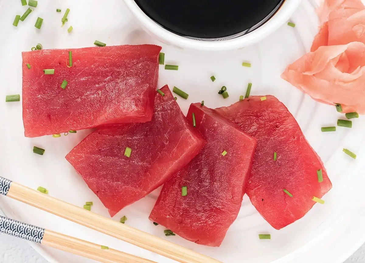 Tuna sashimi on a white plate.