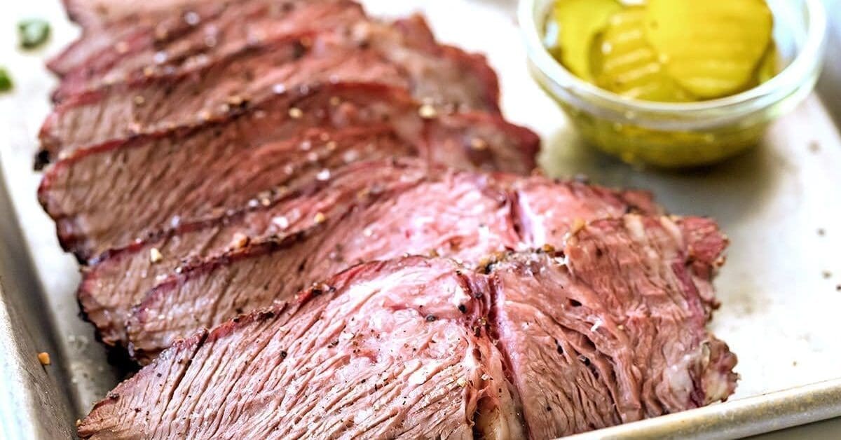 Juicy smoked chuck roast on a cutting board.