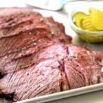 Sliced smoked chuck roast on a serving sheet for beef chuck roast recipes list.
