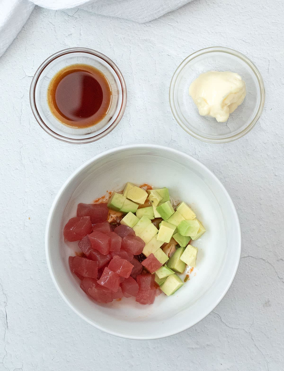Tuna and avocado in a white bowl.