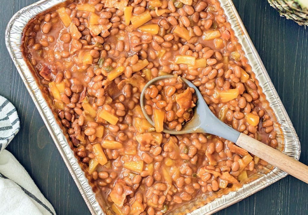 smoked baked beans in an aluminum pan.