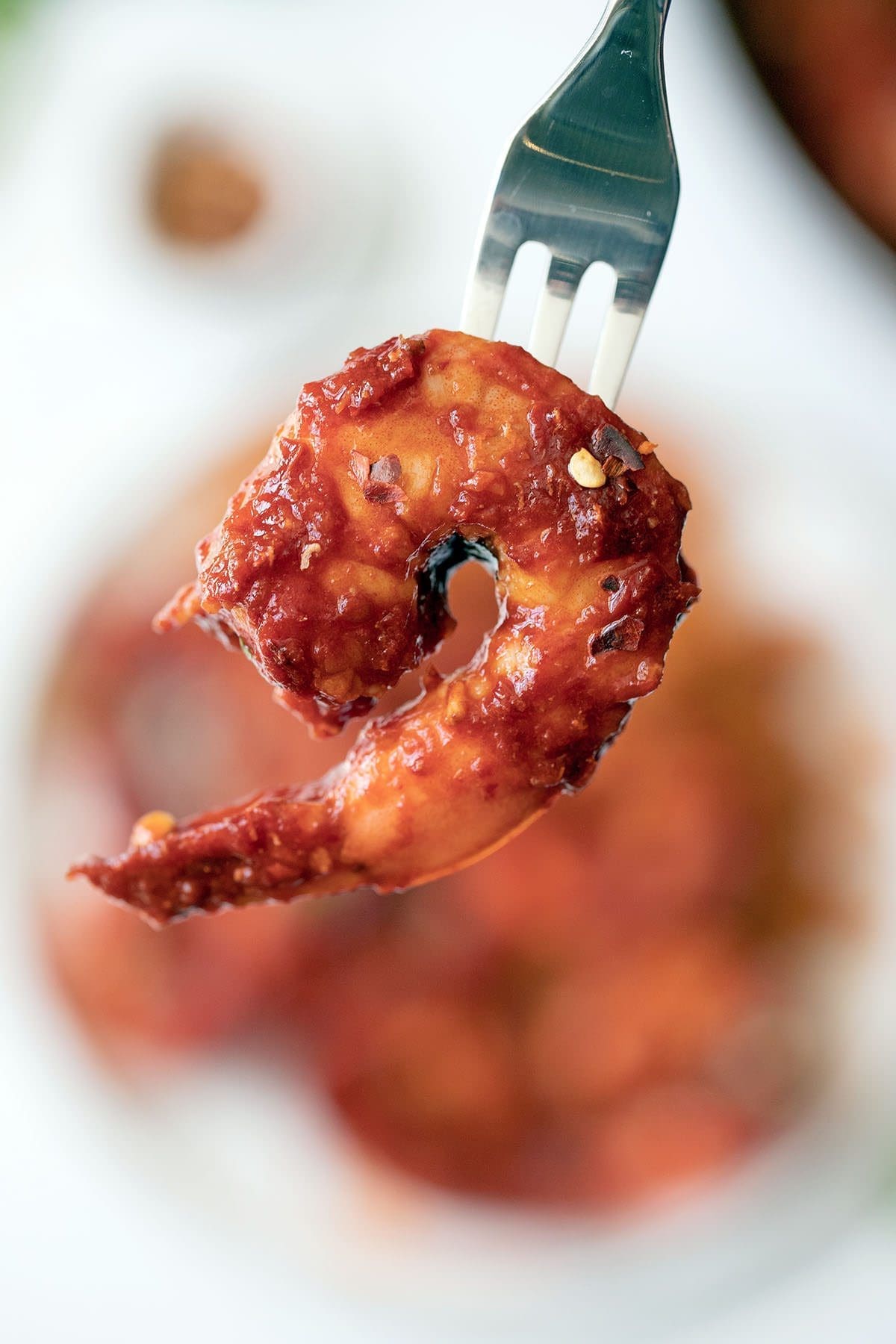 Deviled shrimp on a fork.