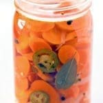 large clear jar of Mexican pickled carrots.