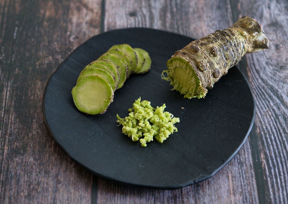 grated wasabi root on a black plate.