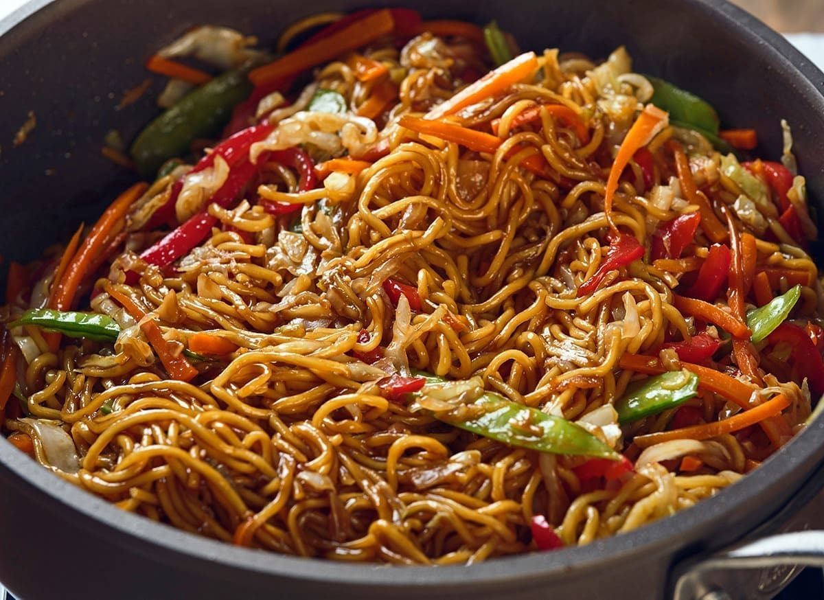 Noodles and vegetables in a pan.