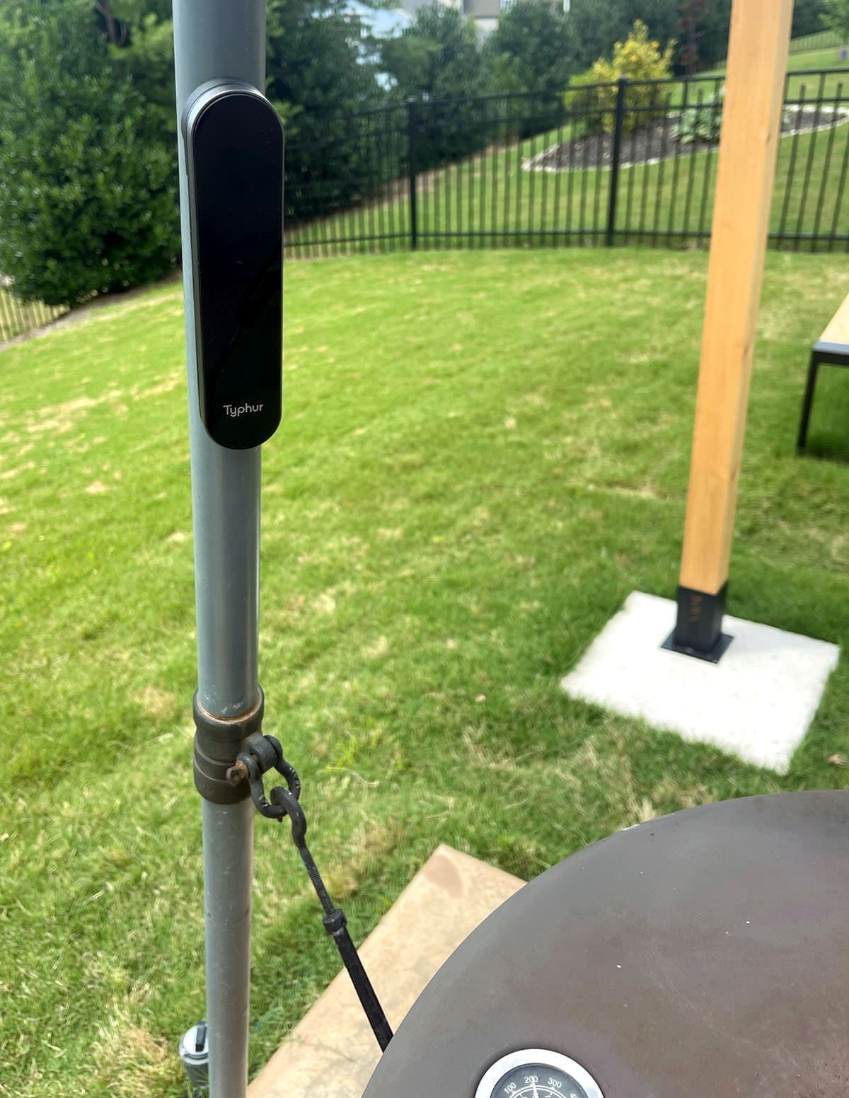 Meat thermometer attached to the leg of a smoking unit.