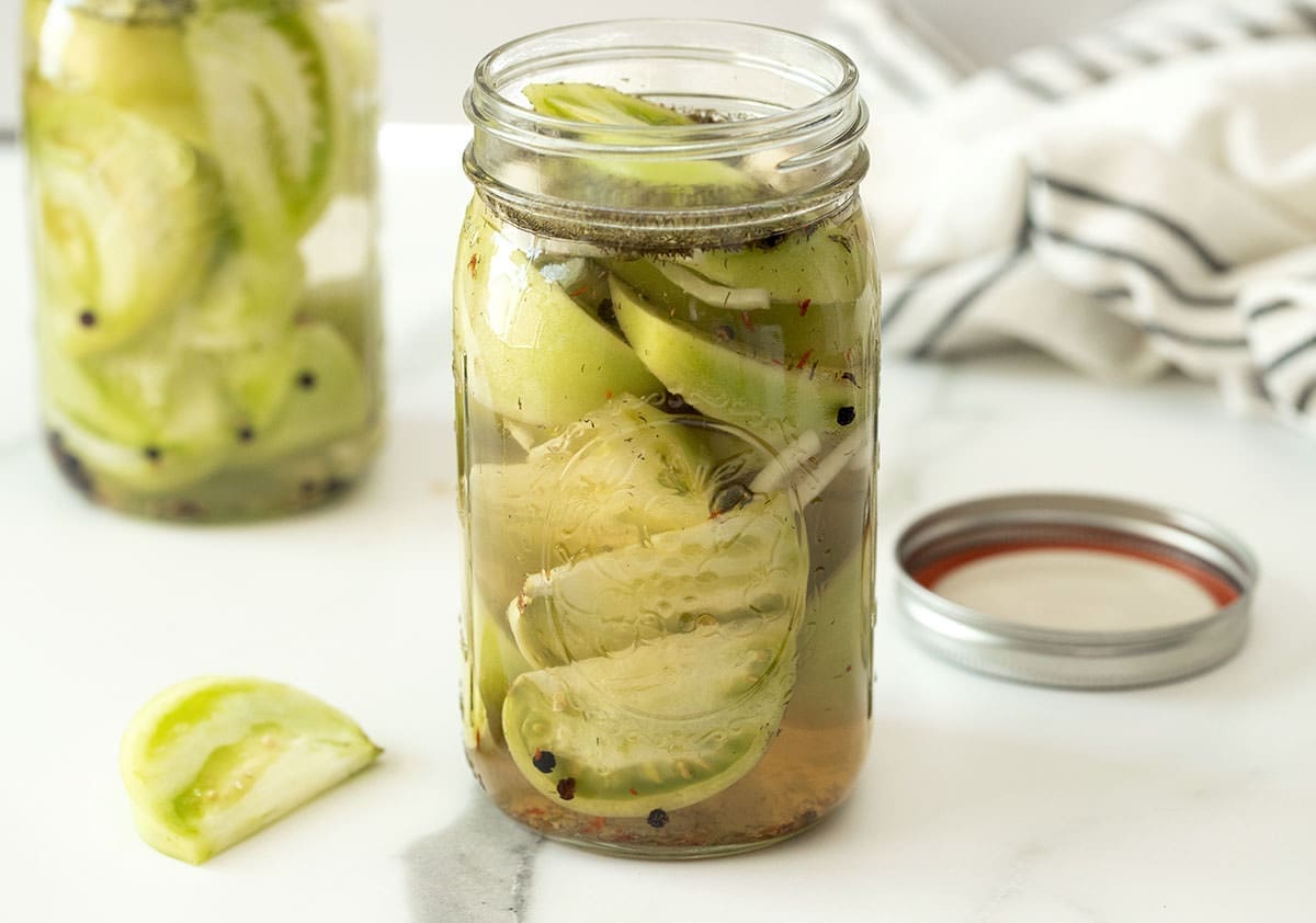 Pickled vegetables in a glass jar and brine.