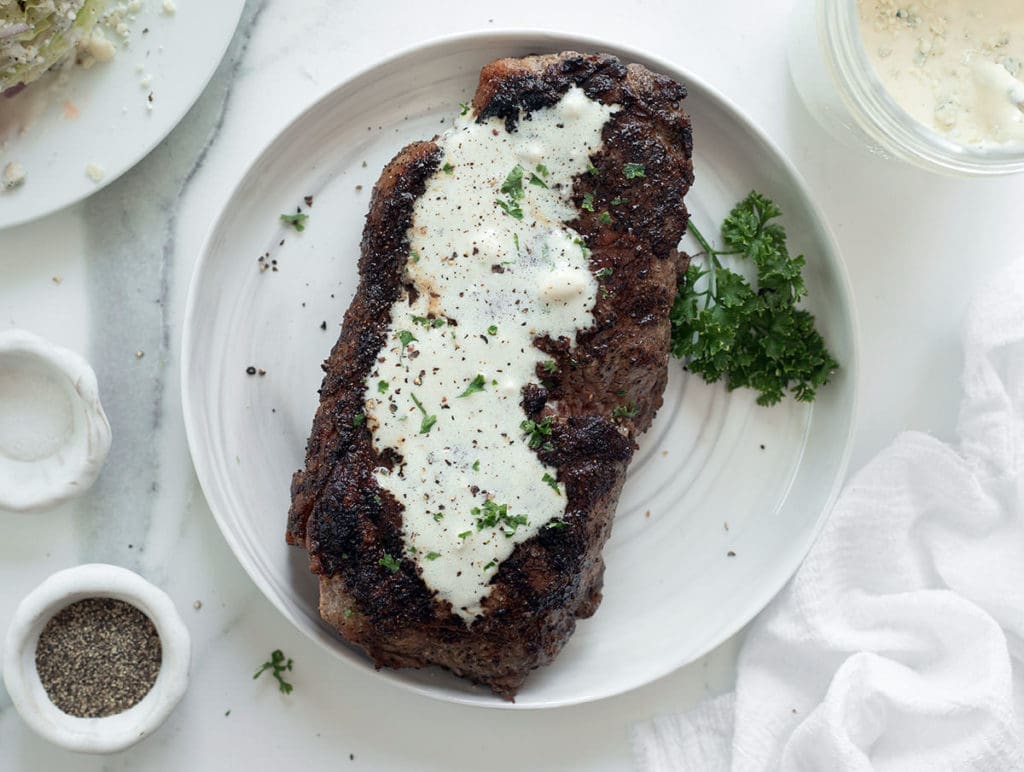 Blue cheese sauce over steak.