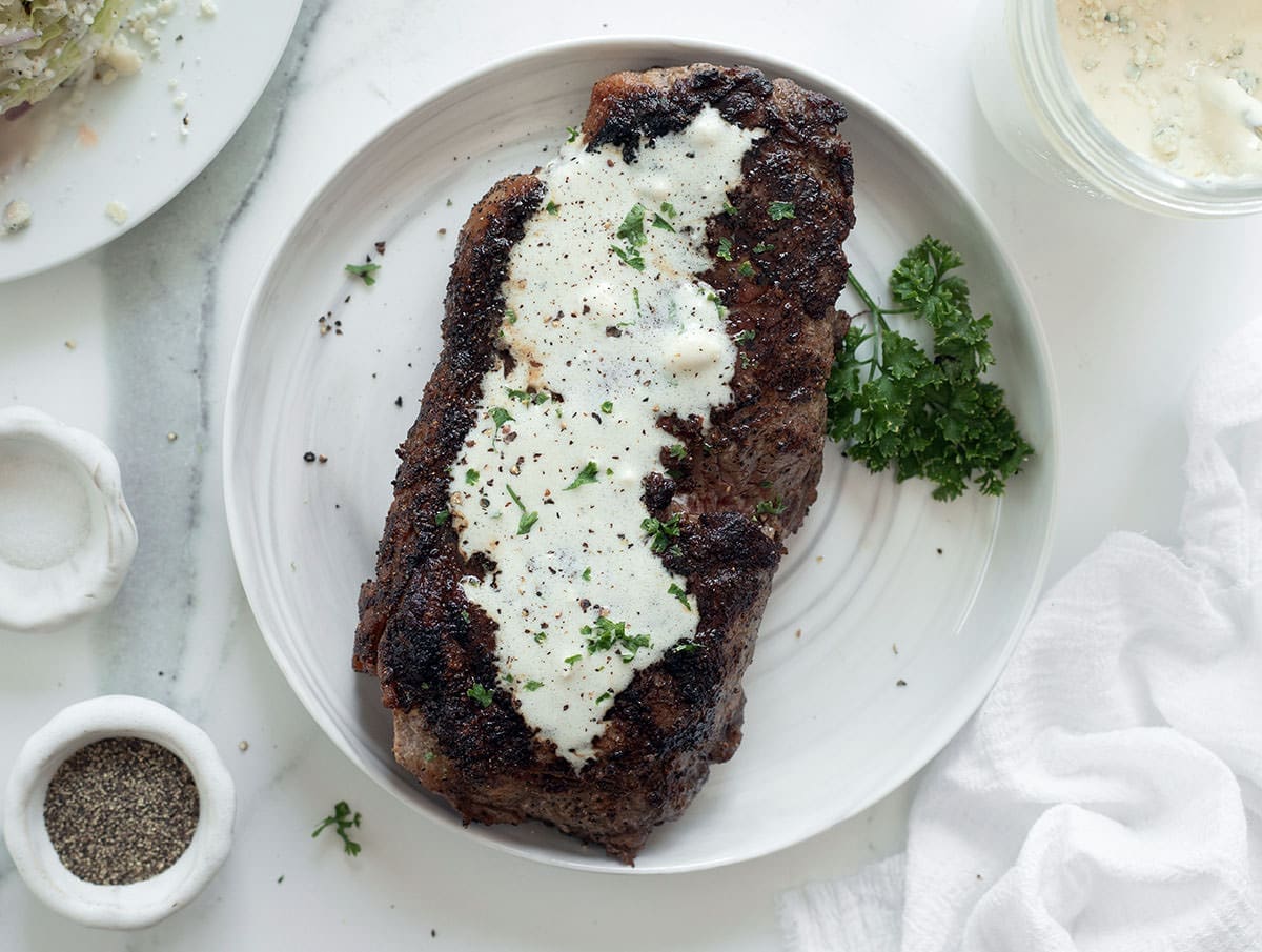 Steak with blue cheese sauce on it.