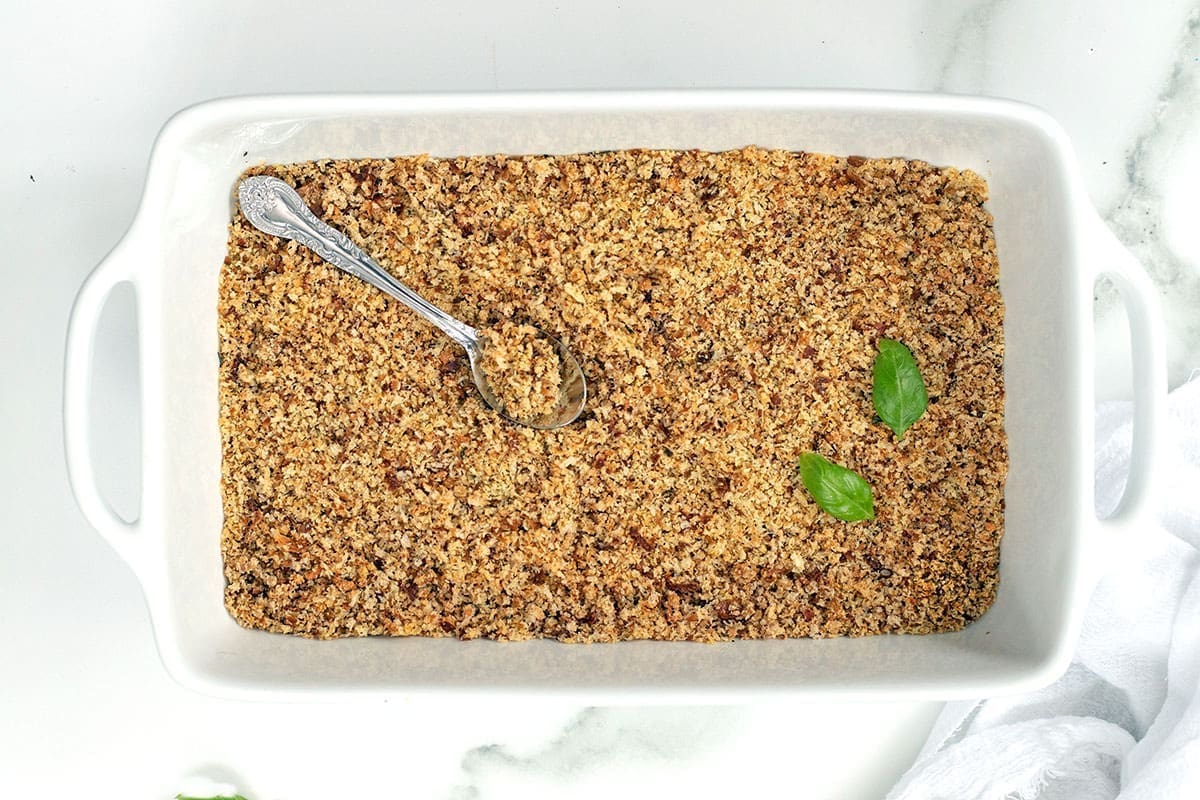 10 Egg Substitutes For Meatballs 1 Pangrattato in a white baking dish with silver spoon.
